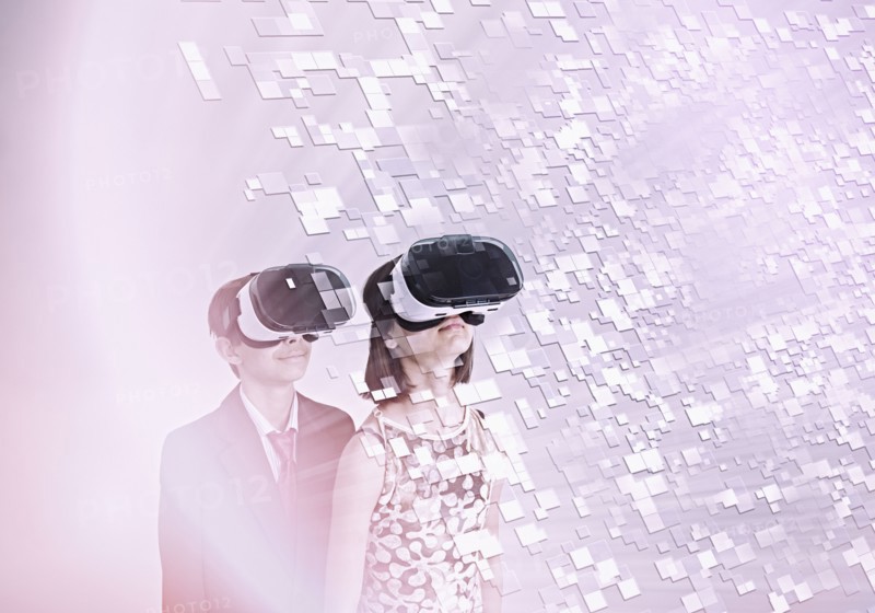 Mixed Race brother and sister using vr goggles