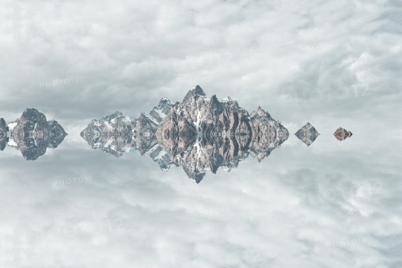 Mirror image of mountains and clouds