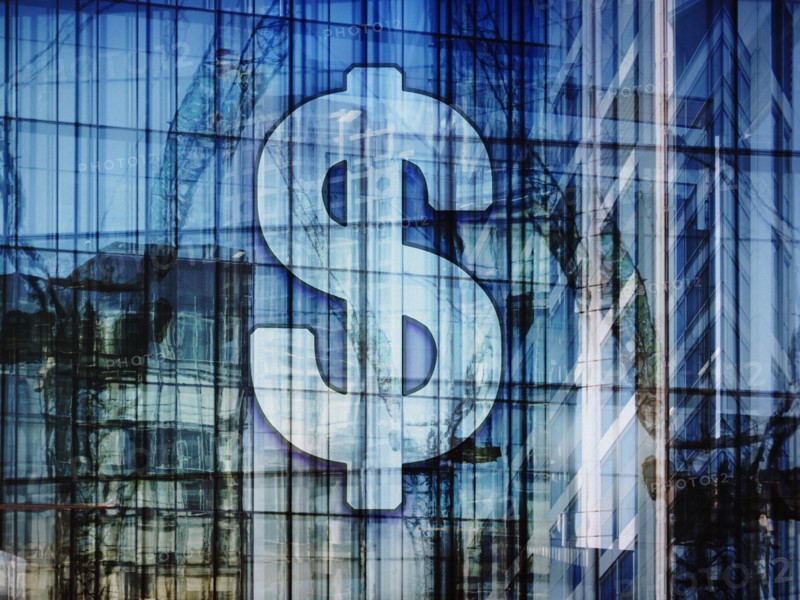 Dollar sign on highrise and construction cranes