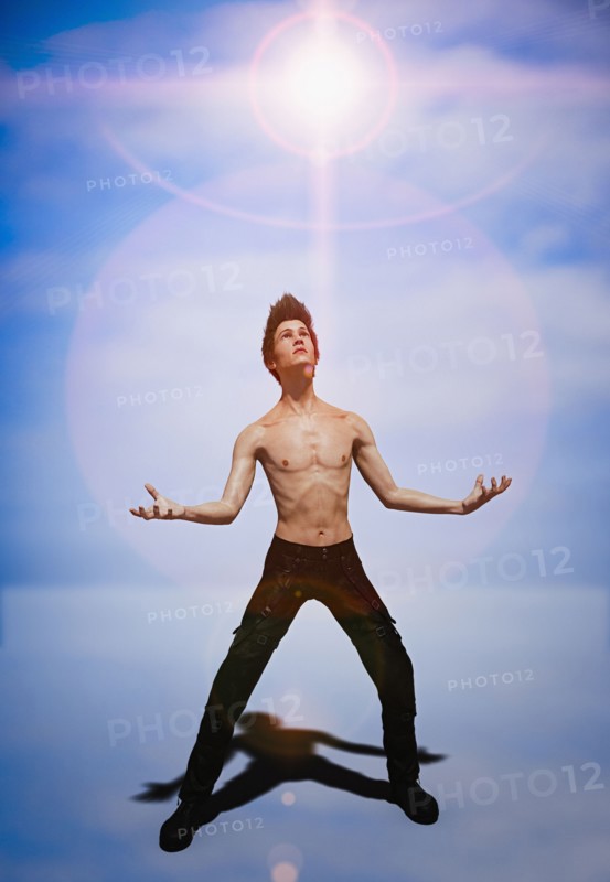 Shirtless man looking at glowing sky