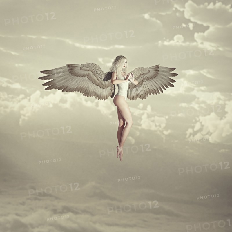 Woman angel flying in clouds