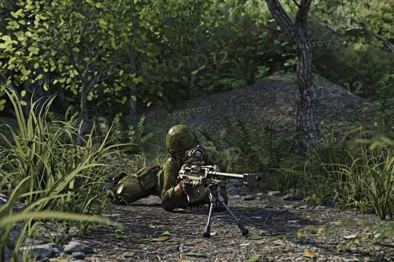 Futuristic soldier laying on the ground aiming rifle