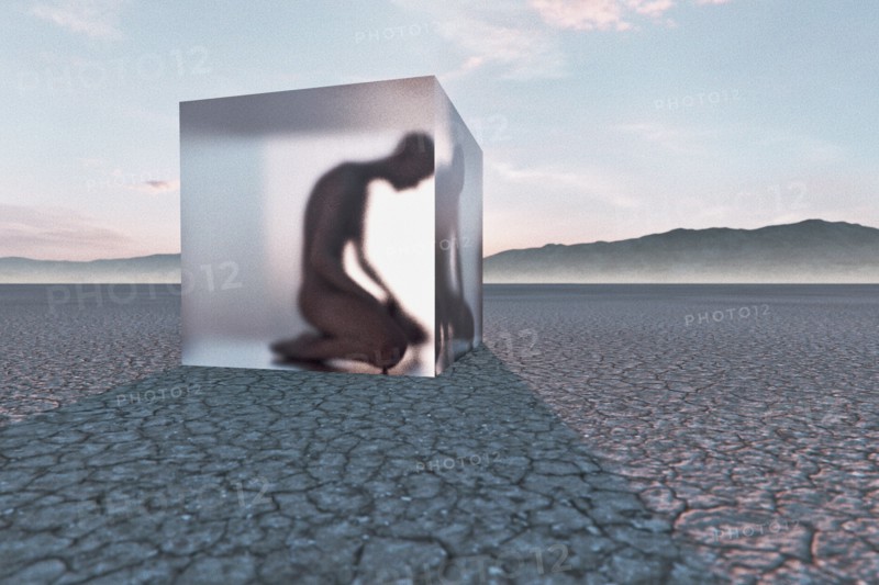 Person frozen in suspended animation in desert