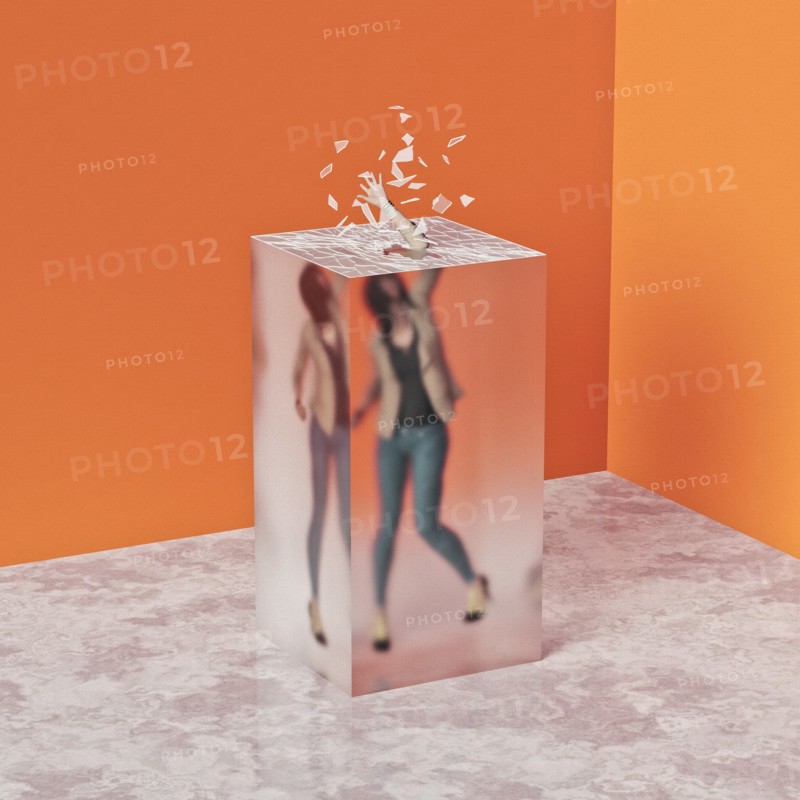 Woman breaking through glass ceiling