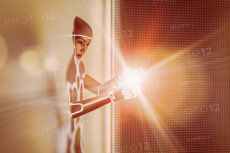 Light glowing in hands of futuristic woman emerging from wall