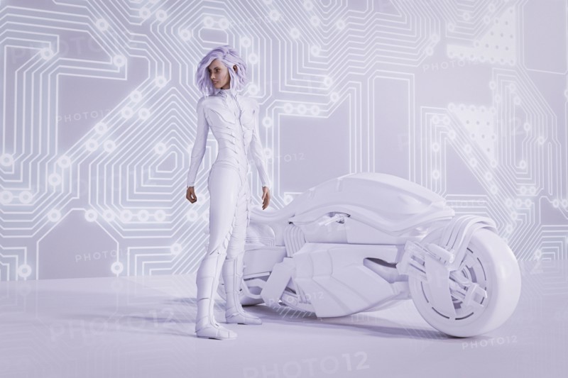 Futuristic woman near circuit board wall with white motorcycle