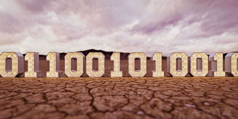 Illuminated binary code in desert