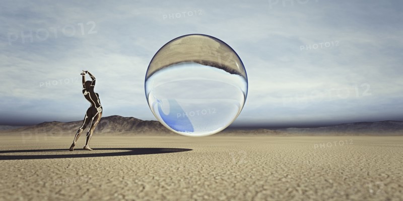 Futuristic woman watching floating sphere in desert