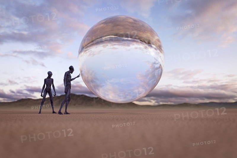 Aliens examining floating sphere in desert