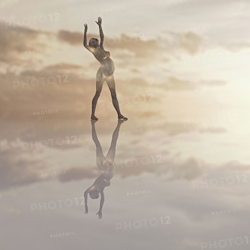 Futuristic expectant mother standing in clouds