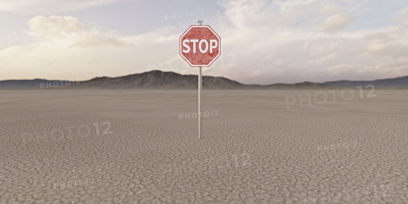 Stop sign in barren desert