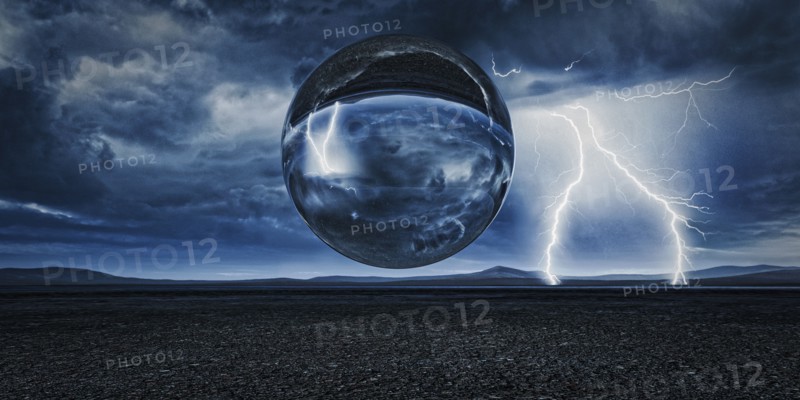 Sphere floating in remote landscape