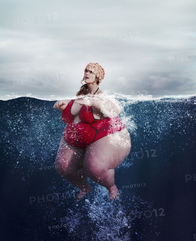 Underwater review of overweight woman swimming