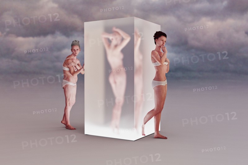 Older woman walking into cube changing to younger woman