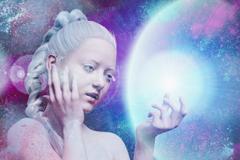 Curious woman examining glowing energy