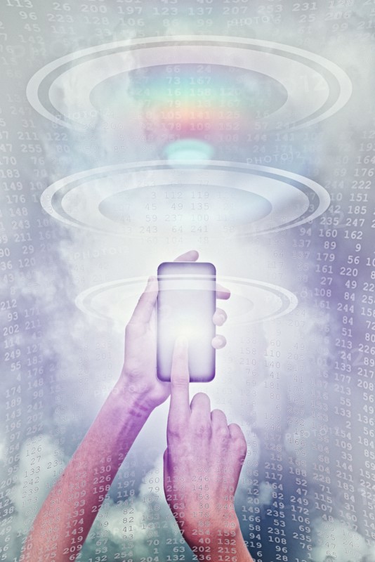 Hands of mixed race boy using cell phone in cyberspace