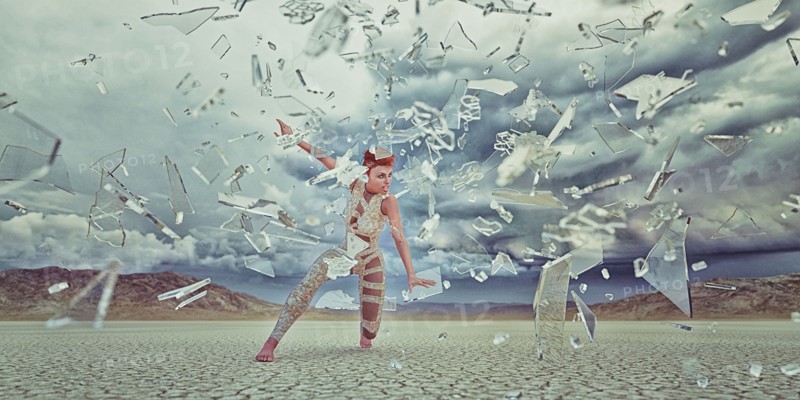 Shards of glass surrounding futuristic woman in desert