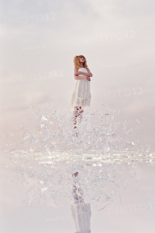 Woman hovering in shards of glass