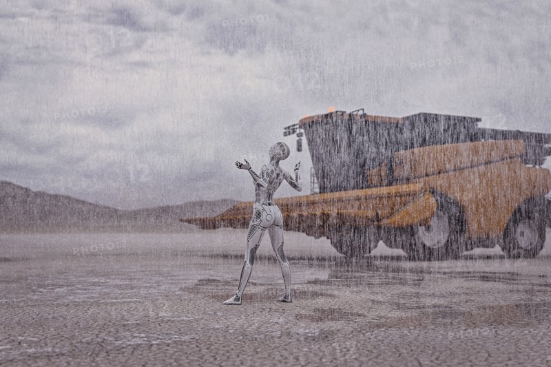 Robot looking up at rain in desert