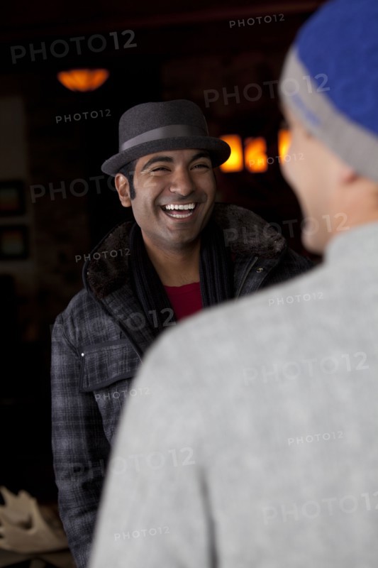 Smiling man socializing with friend