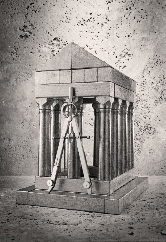Silver model of pillars and archway with compass