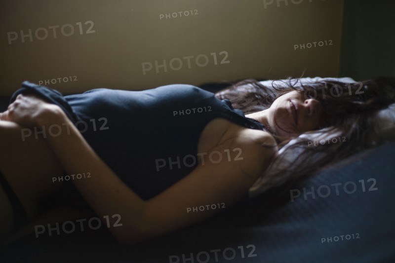 Sleeping mixed race woman laying in bed