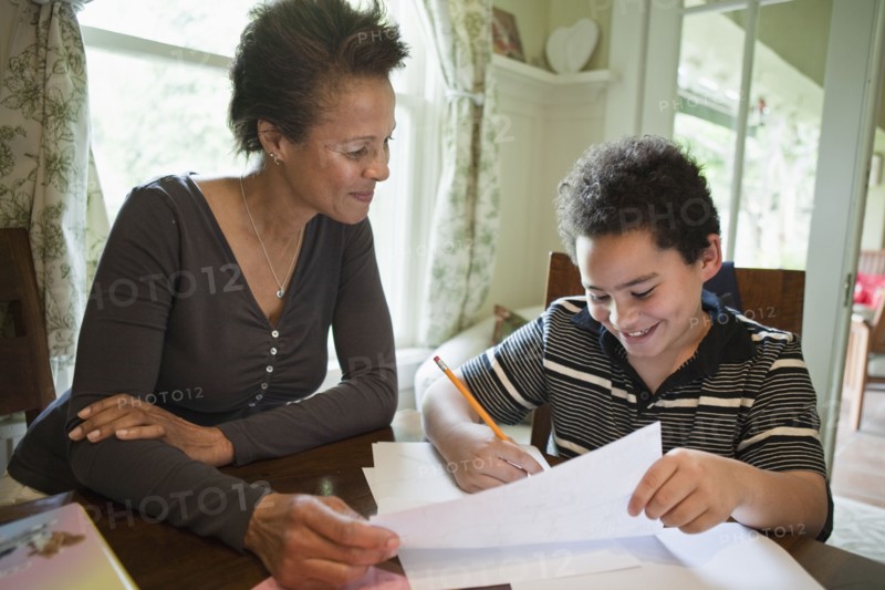 Grandmother helping grandson with homework