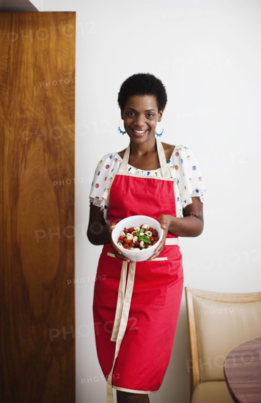 African American woman holding a bowl of salad
