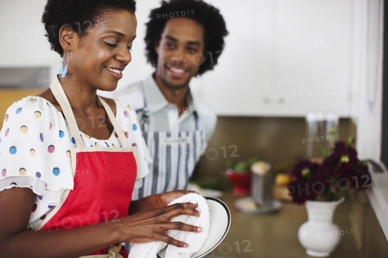 African American woman washing dishes