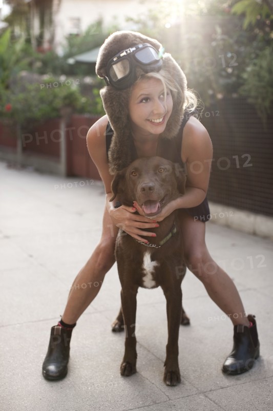 Caucasian woman in fur hat riding dog