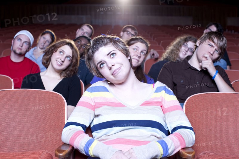 Caucasian woman watching movie in theater