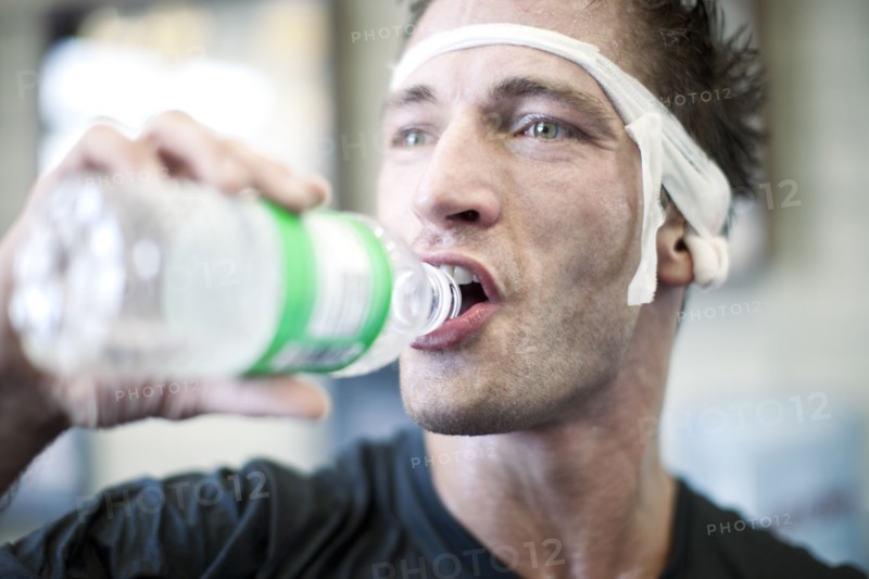 Bandaged man drinking water