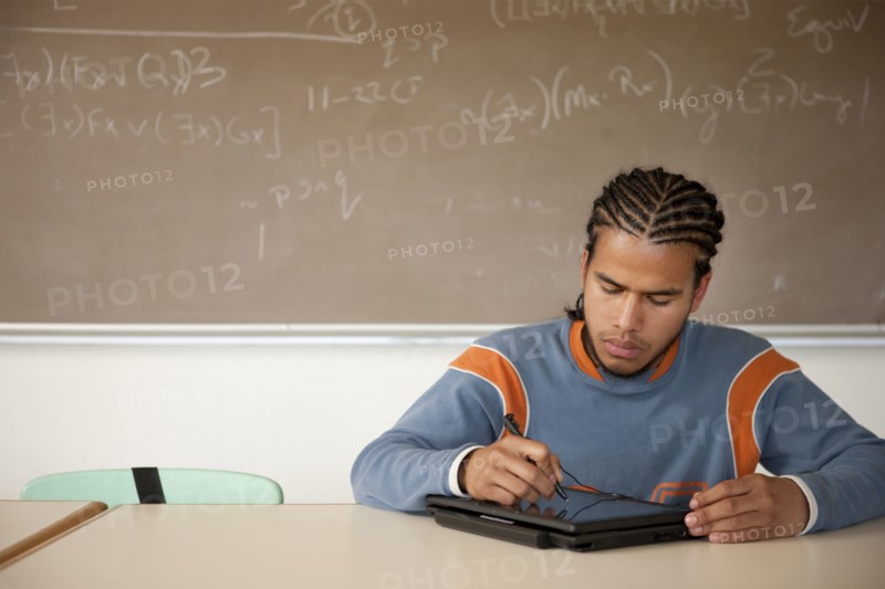 Peruvian student studying in classroom on laptop