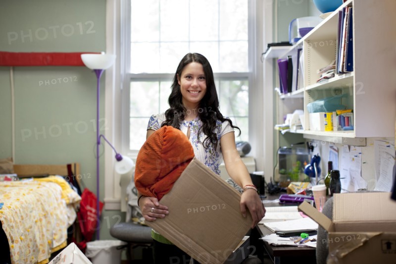 Mixed race woman moving into college dorm room