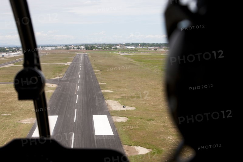 Cockpit view of airplane landing on airport runway
