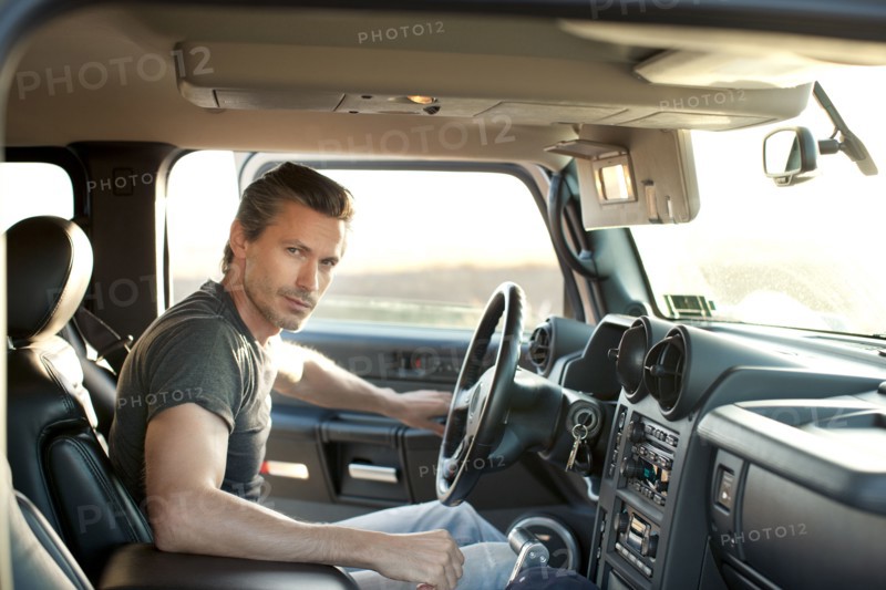 Caucasian man getting into truck