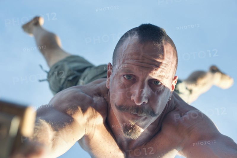Caucasian man doing handstand