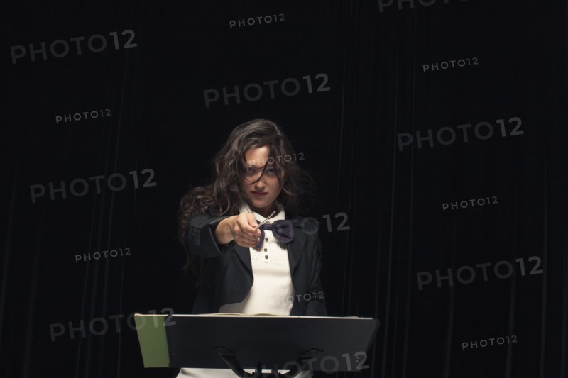 Mixed race conductor pointing baton