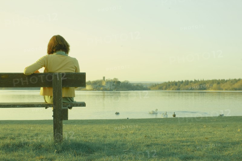 Caucasian teenage girl sitting on park bench