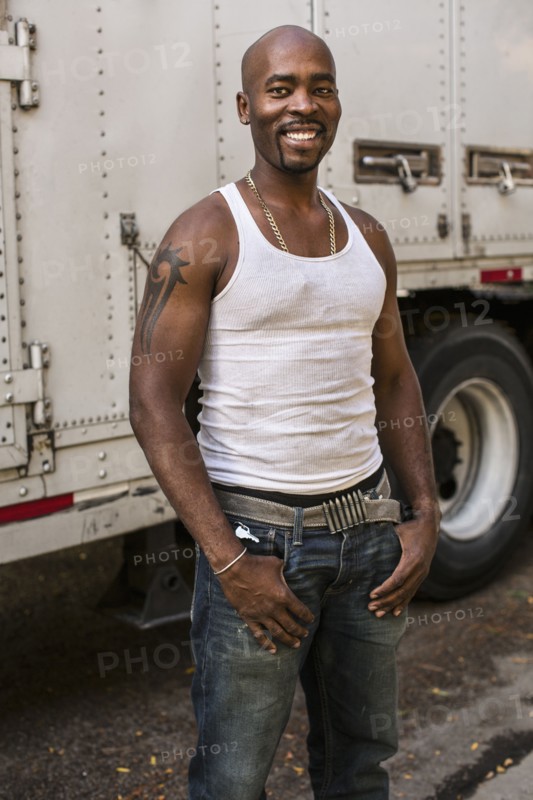 Black man smiling by truck