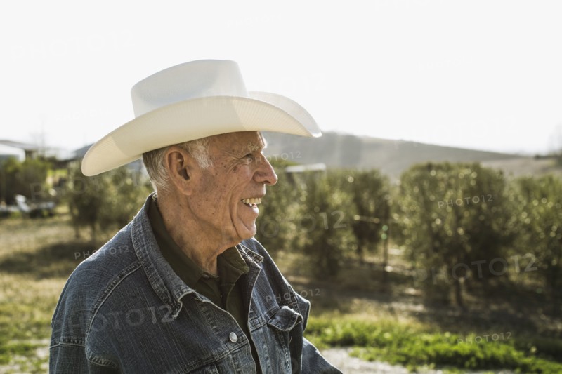 Hispanic farmer smiling in vineyard