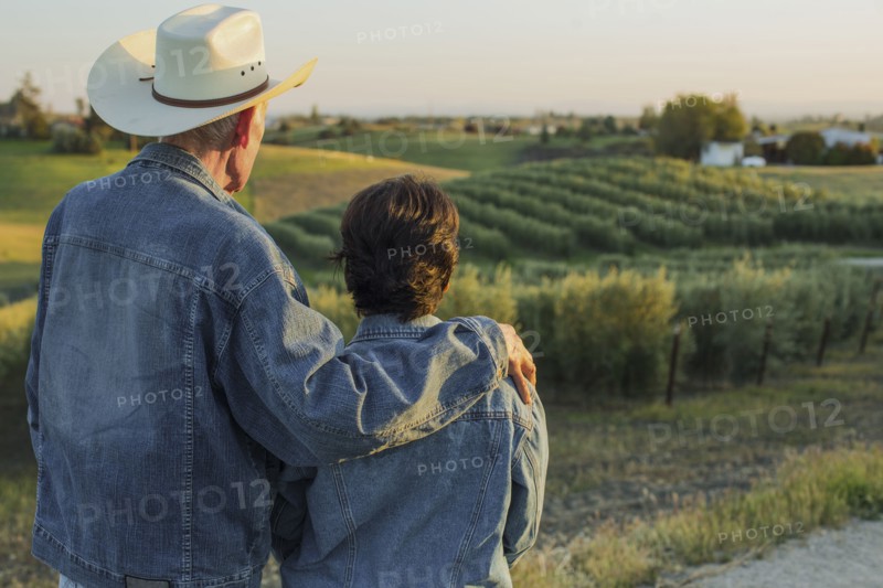 Hispanic farmers standing in vineyard