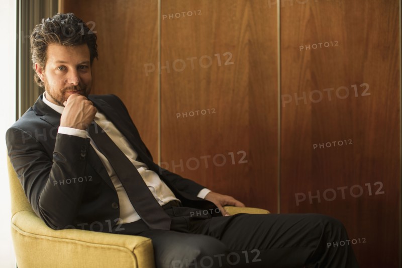 Caucasian businessman sitting in armchair
