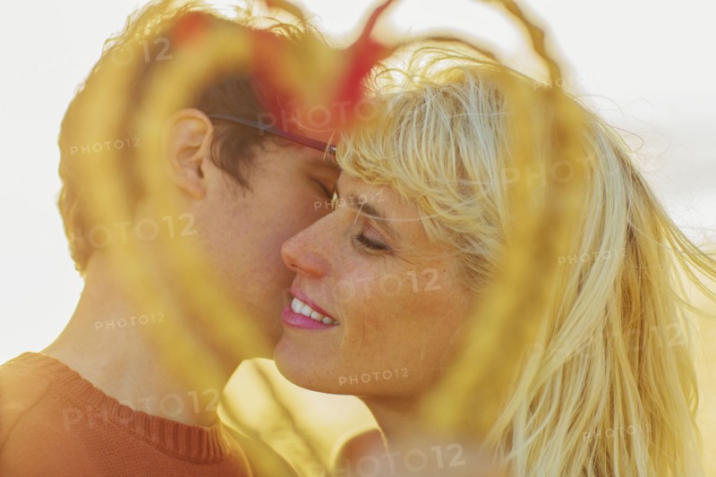 Caucasian couple holding woven heart