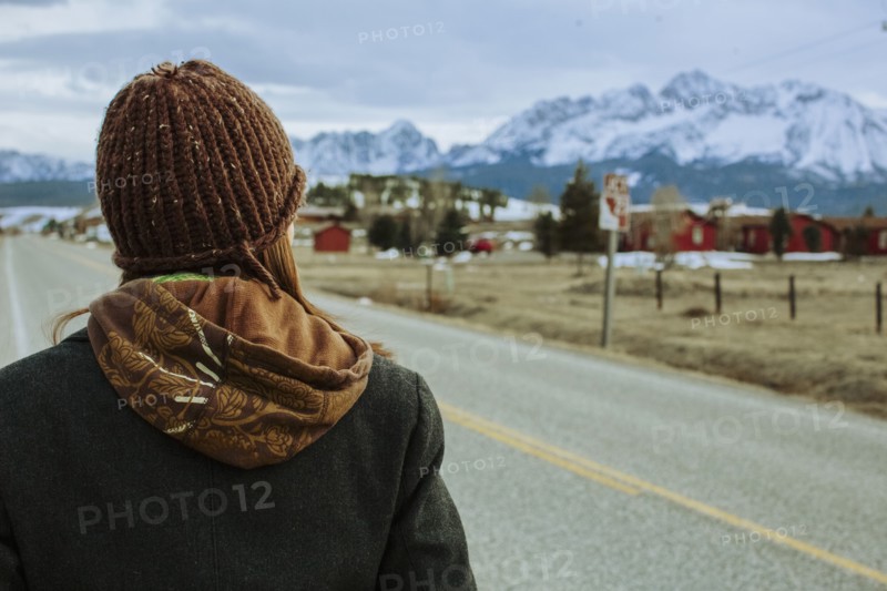 Caucasian woman walking on rural road