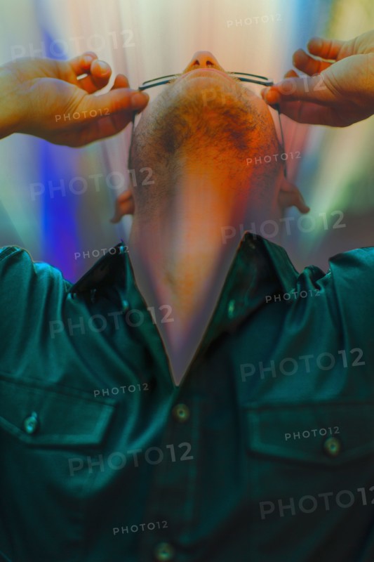Caucasian man looking through glasses