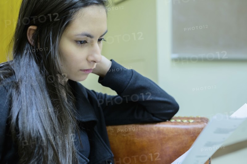 Middle Eastern student reading in classroom