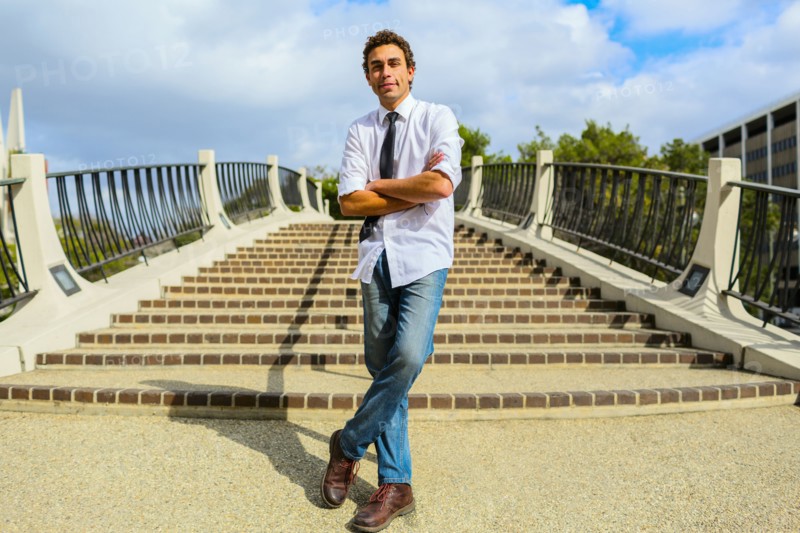 Hispanic businessman standing by urban steps