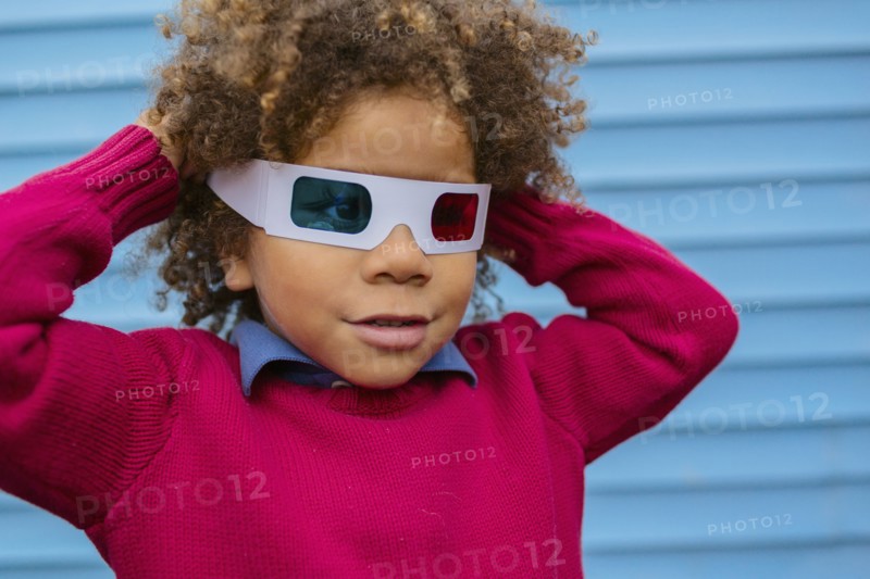 Pacific Islander boy wearing 3D glasses