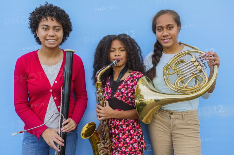 Pacific Islander girls holding musical instruments
